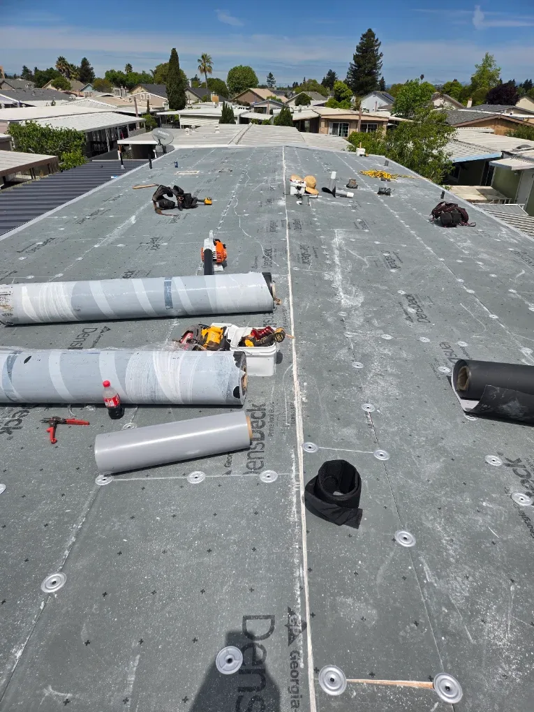 Roofing rolls and materials on a low-slope roof